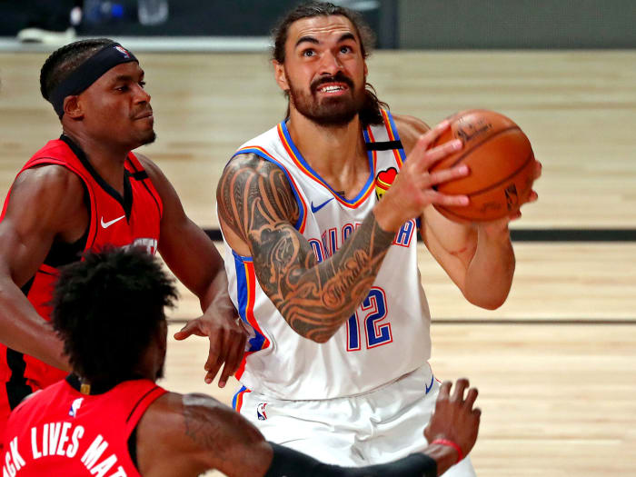 Aug 20, 2020; Lake Buena Vista, Florida, USA; Oklahoma City Thunder center Steven Adams (12) shoots the ball against Houston Rockets forward Robert Covington (33) during the first quarter in an NBA basketball first round playoff game of the 2020 NBA playoffs at AdventHealth Arena.